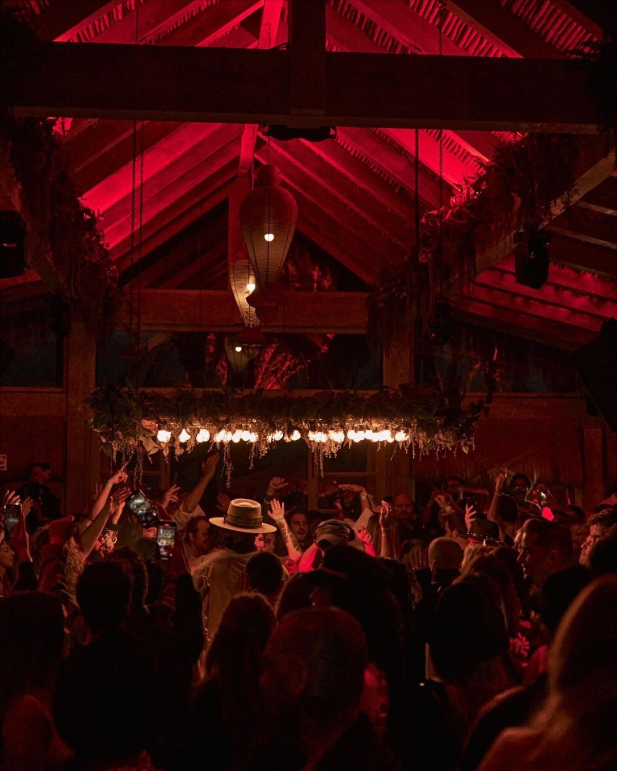 A busy Marbella venue at night under red lighting