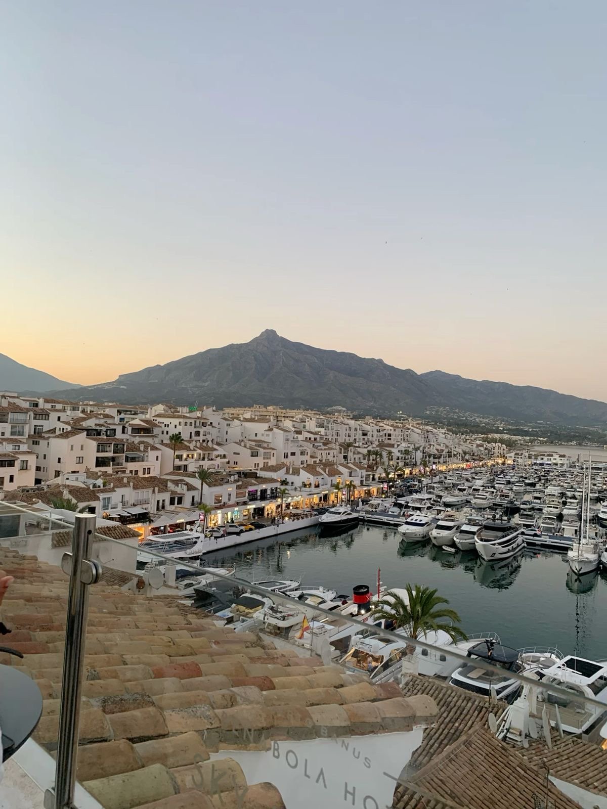 Puerto Banús marina at sunset, with yachts moored below the La Concha mountain